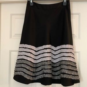 J. McLaughlin black skirt with light gray and dark gray gathers at the bottom.